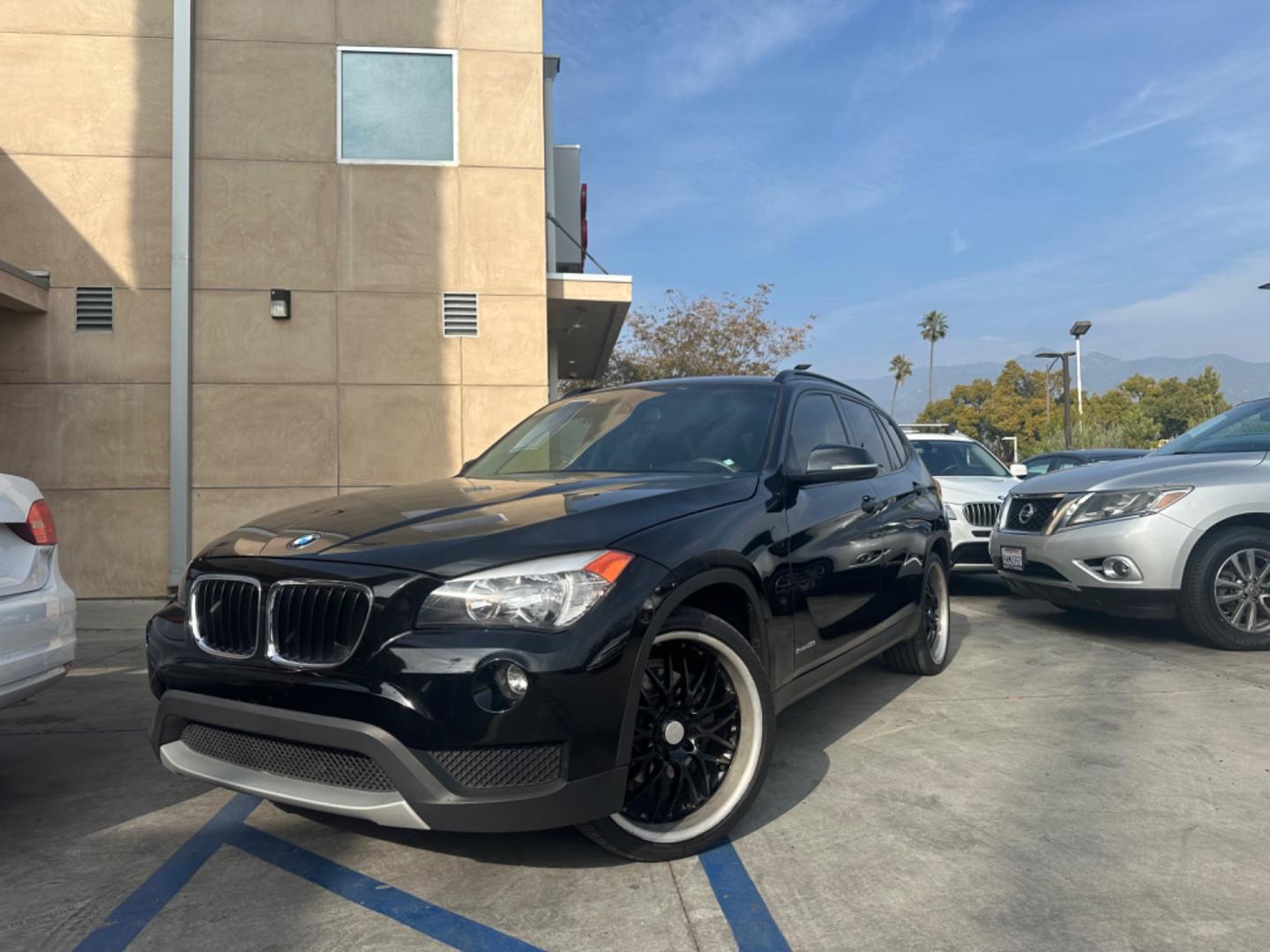 2014 Black /Black BMW X1 (WBAVM1C57EV) with an 4 CYLINDER engine, Automatic transmission, located at 30 S. Berkeley Avenue, Pasadena, CA, 91107, (626) 248-7567, 34.145447, -118.109398 - Photo#0